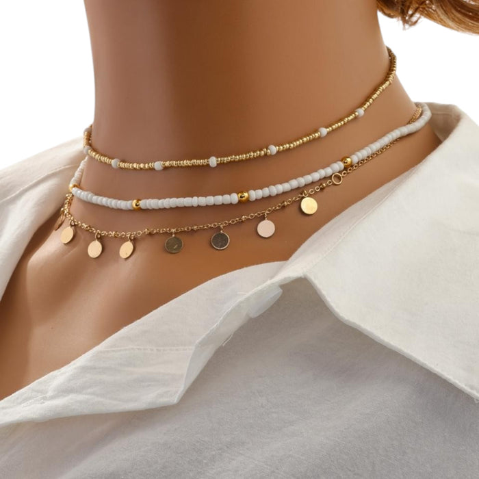 Three-layered gold necklace set with pearl beads, rhinestones, and disc pendants in a boho style at spotngrab lebanon