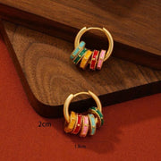 Gold hoop earrings with pastel enamel clover and geometric charm accents available at spotngrab lebanon