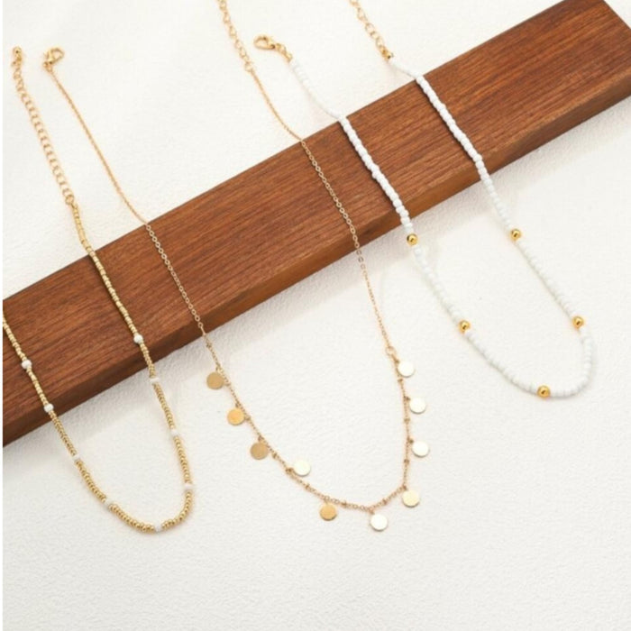 Three-layered gold necklace set with pearl beads, rhinestones, and disc pendants in a boho style at spotngrab lebanon
