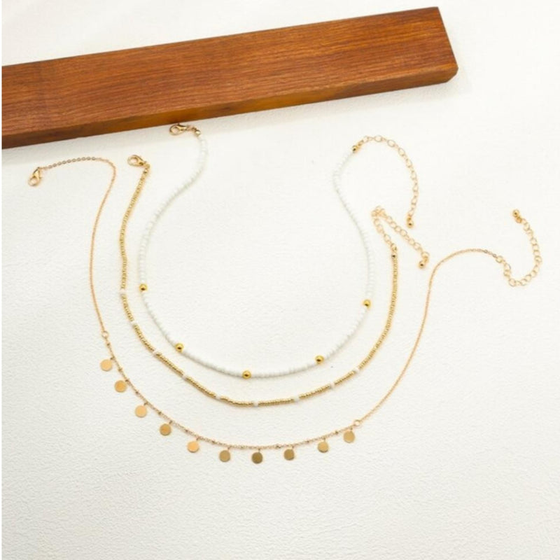 Three-layered gold necklace set with pearl beads, rhinestones, and disc pendants in a boho style at spotngrab lebanon