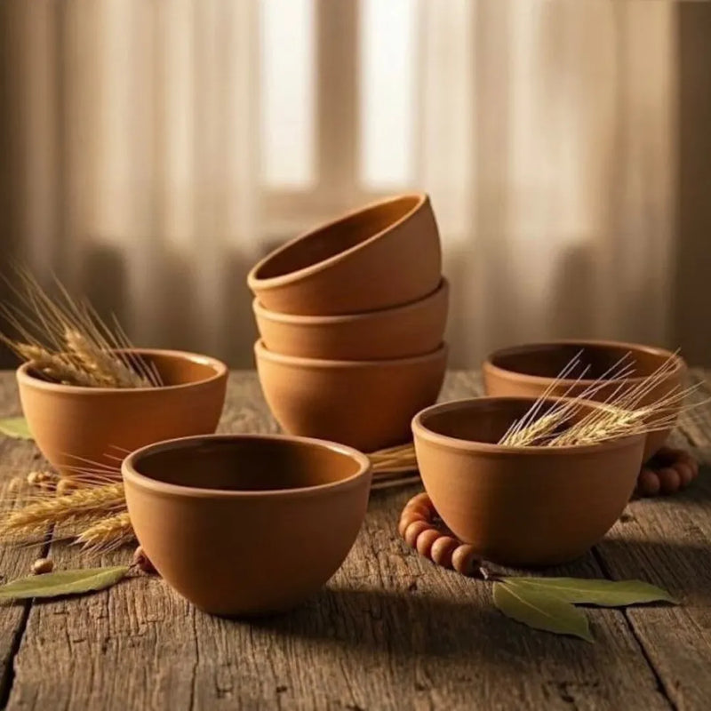 A set of six hand-sized terracotta clay serving bowls showing a matte natural earth finish and a smooth shiny glaze on the inside on Spotngrab Lebanon.