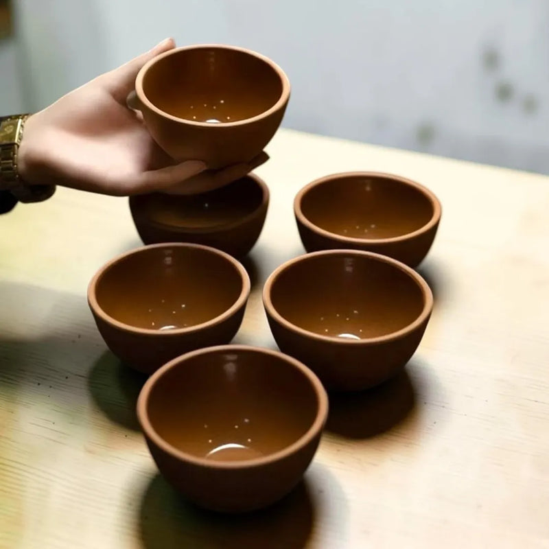 A set of six hand-sized terracotta clay serving bowls showing a matte natural earth finish and a smooth shiny glaze on the inside on Spotngrab Lebanon.