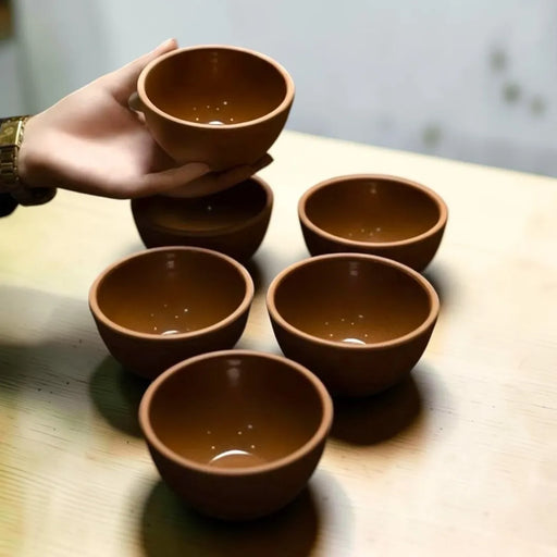 A set of six hand-sized terracotta clay serving bowls showing a matte natural earth finish and a smooth shiny glaze on the inside on Spotngrab Lebanon.