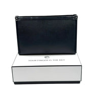 Black leather men's business clutch bag with a biometric fingerprint lock resting on a white box on Spotngrab Lebanon.