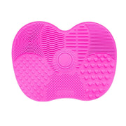 Close-up of different textures on a pink silicone brush cleaner pad.