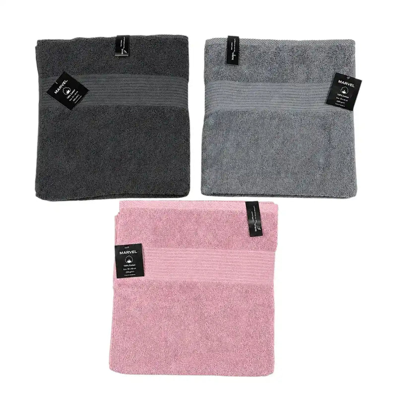 Marvel 100% cotton bath towels folded in dark grey, light grey, and pink on Spotngrab Lebanon.