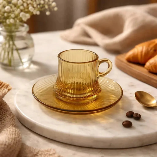 Mini amber glass pocillo cup measuring 5x6cm with a distinct vertical ribbed pattern sitting centered on its matching amber glass saucer on Spotngrab Lebanon.