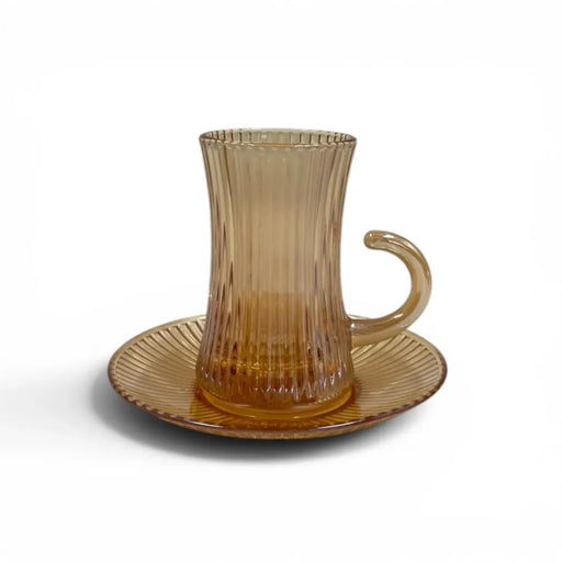 A complete 1 piece amber glass tea service set showing 100ml vertical ribbed cups with handles sitting on their matching fluted saucers on Spotngrab Lebanon.
