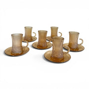 A complete 12-piece amber glass tea service set showing six 100ml vertical ribbed cups with handles sitting on their matching fluted saucers on Spotngrab Lebanon.