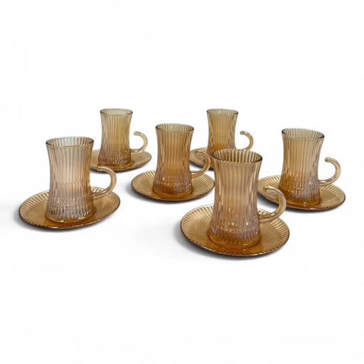 A complete 12-piece amber glass tea service set showing six 100ml vertical ribbed cups with handles sitting on their matching fluted saucers on Spotngrab Lebanon.