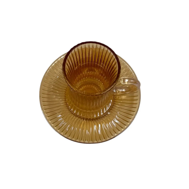 A complete 1 piece amber glass tea service set showing 100ml vertical ribbed cups with handles sitting on their matching fluted saucers on Spotngrab Lebanon.