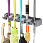 Gray wall-mounted organizer holding various cleaning tools including brooms and scrubbers.