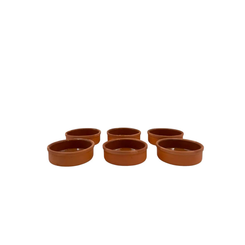 A set of six small 11x3.5cm round shallow clay cooking pots showing a glossy glazed interior and matte terracotta red clay exterior on Spotngrab Lebanon.