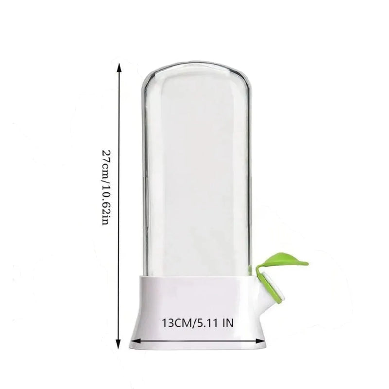 Vertical clear herb saver container storing fresh mint and cilantro inside a fridge door shelf.
