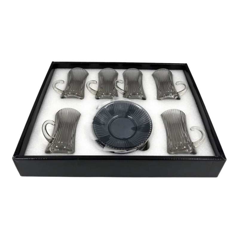 A complete a box of 12-piece smoky grey glass tea service set showing six vertical ribbed glasses with handles sitting on their matching fluted saucers on Spotngrab Lebanon.