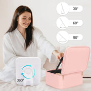 A woman applying cosmetics in a dimly lit room using the bright illumination from a pink portable smart vanity mirror bag.